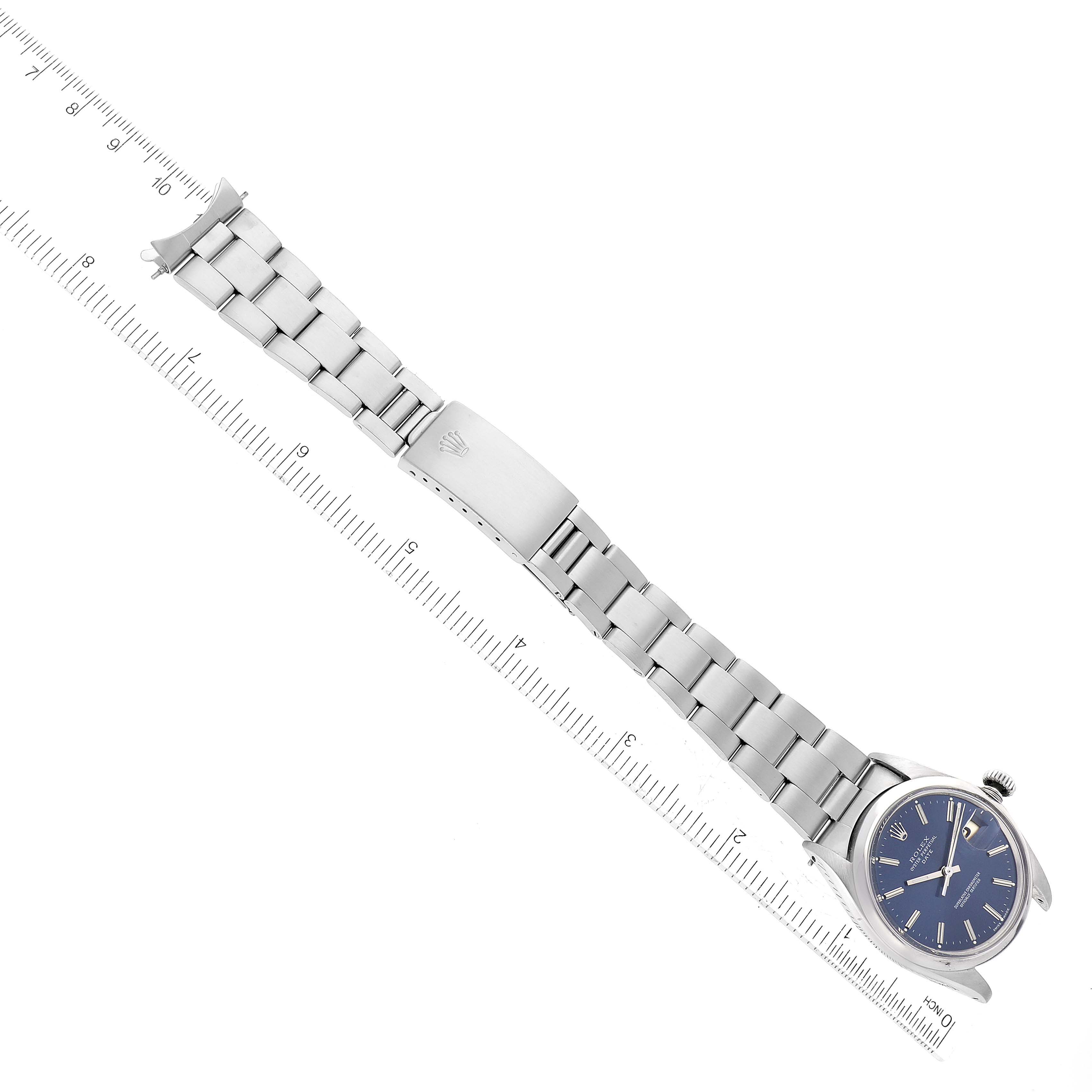 The image shows a Rolex Vintage Collection 1500 Men's Stainless Steel Blue Dial 1500 Men's Stainless Steel Blue Dial watch at an angled top view, clearly displaying the face and metal bracelet alongside a measurement scale.