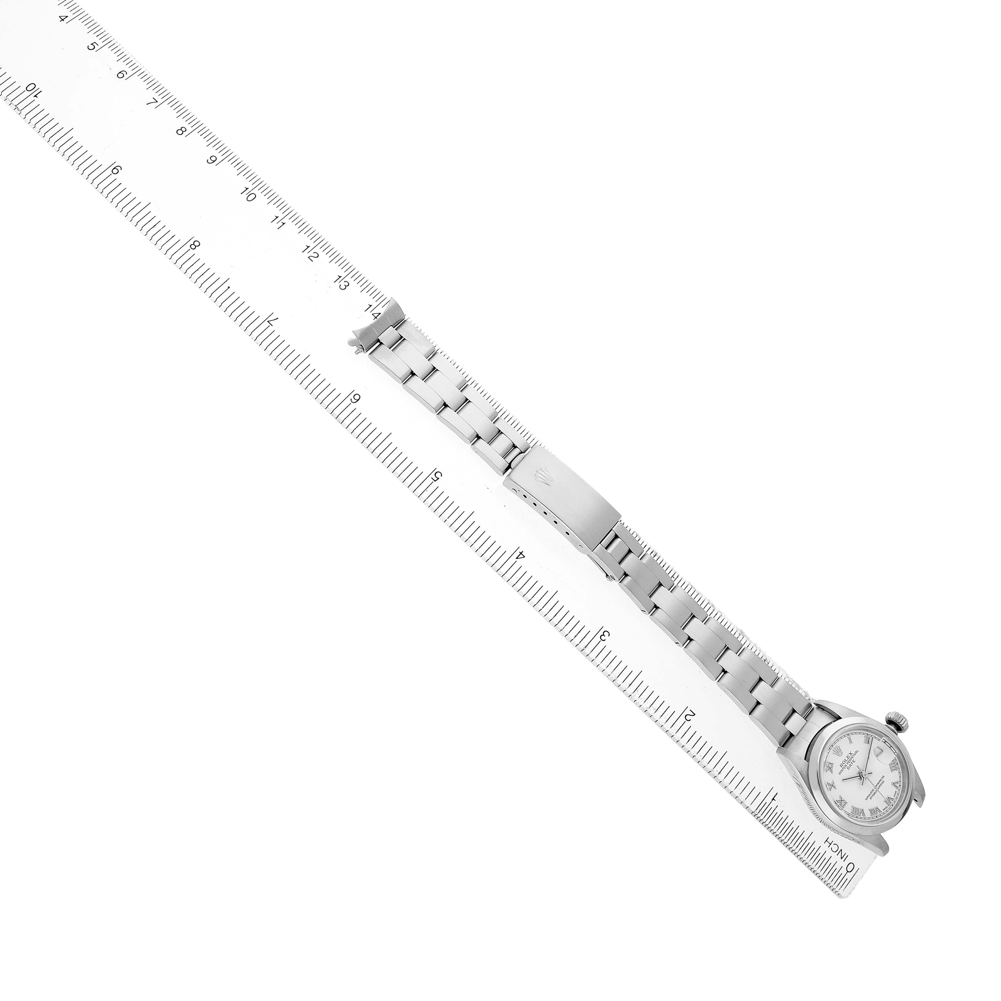 This image shows a side angle of the Rolex Date 79160 Women's Stainless Steel White Dial model, focusing on the watch band alongside a ruler.