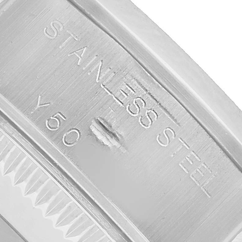 The image shows an angled close-up of the Rolex Date 79160 Women's Stainless Steel White Dial model's stainless steel bezel marking.