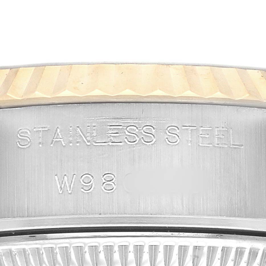 The image shows the side profile of a Rolex Datejust 69173 Women's Steel and Gold (two tone) Champagne Dial, focusing on the stainless steel case with engraved text.