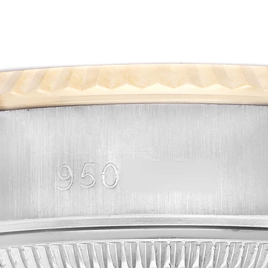 The image shows a close-up of the bezel and edge of the case of a Rolex Datejust 69173 Women's Steel and Gold (two tone) Champagne Dial, highlighting the metal texture and engraving.