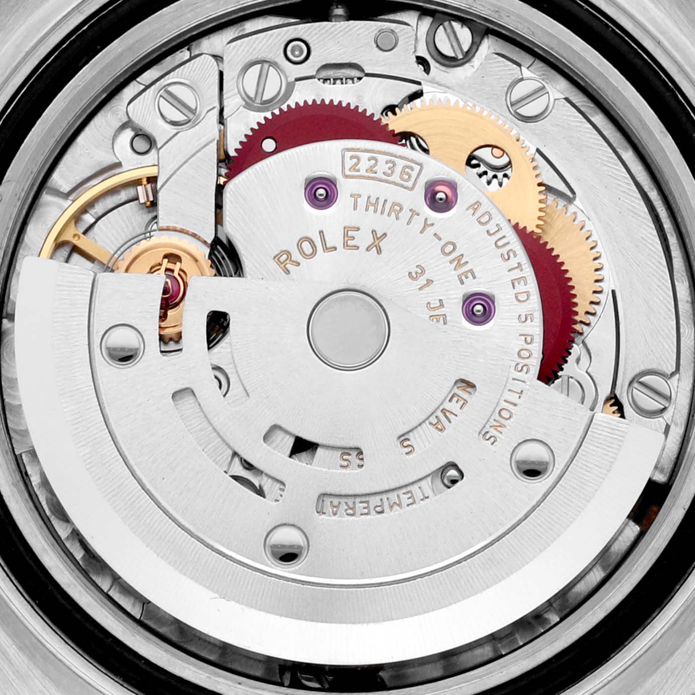 The image shows the intricate internal mechanism of a Rolex Datejust 279174 Women's Stainless Steel White Dial 279174 Women's Stainless Steel White Dial, highlighting gears and the rotor from a top-down angle.