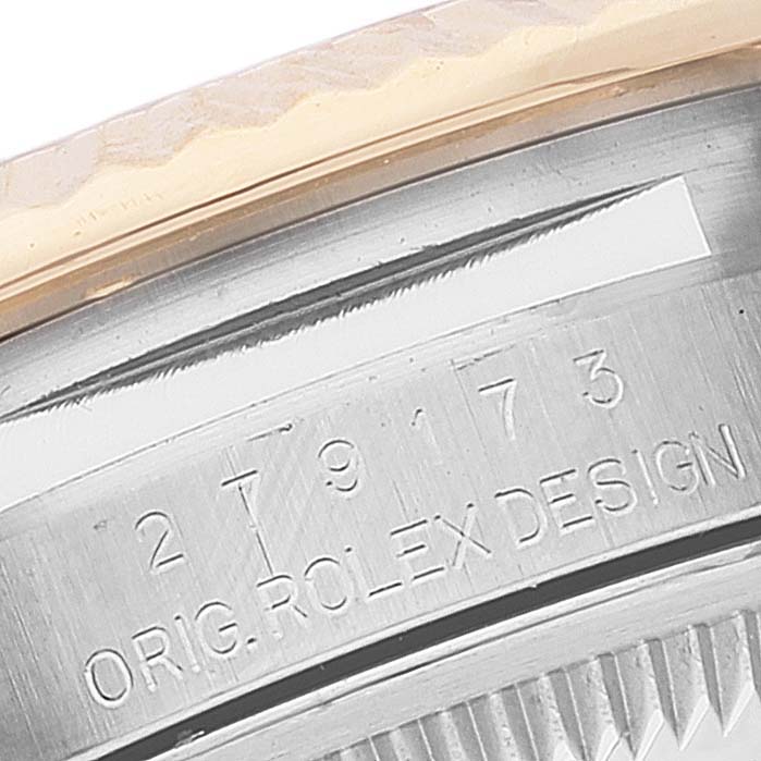 The image shows a close-up of the engraved case back of a Rolex Datejust 279173 Women's Steel and Gold (two tone) Purple Dial 279173 Women's Steel and Gold (two tone) Purple Dial watch, featuring the inscriptions and bezel edge.