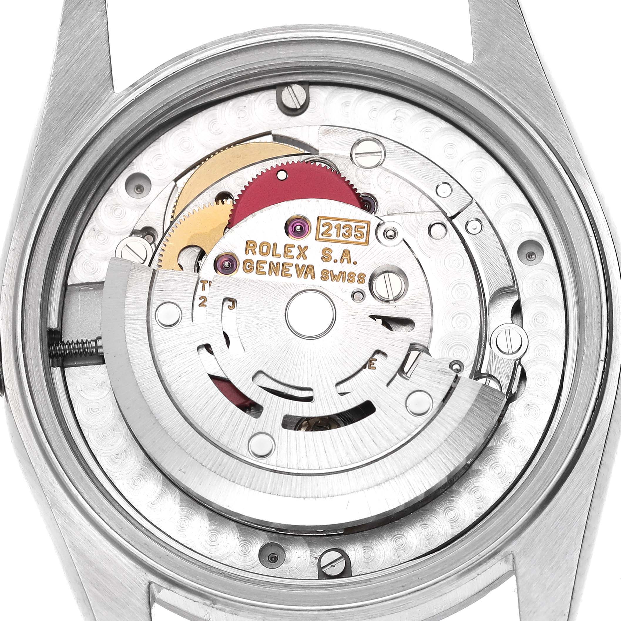 The image shows the internal movement of a mid-size Rolex watch from a top-down angle.