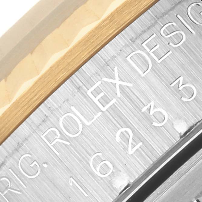 The image shows a close-up of the model number and part of the bezel on a Rolex Datejust 16233 Men's Steel and Gold (two tone) Mother of Pearl Dial 16233 Men's Steel and Gold (two tone) Mother of Pearl Dial watch.