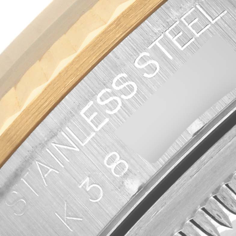 The image shows a close-up of the Rolex Datejust 16233 Men's Steel and Gold (two tone) Mother of Pearl Dial 16233 Men's Steel and Gold (two tone) Mother of Pearl Dial watch's stainless steel and gold bezel.