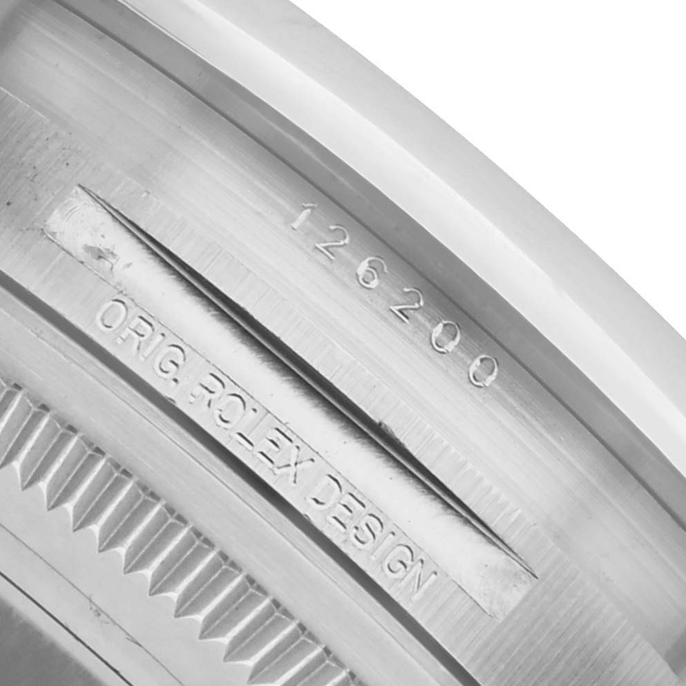 The image shows a close-up of the inner bezel of a Rolex Datejust 126200 Men's Stainless Steel White Dial watch, displaying the model number and "ORIG ROLEX DESIGN" engraving.