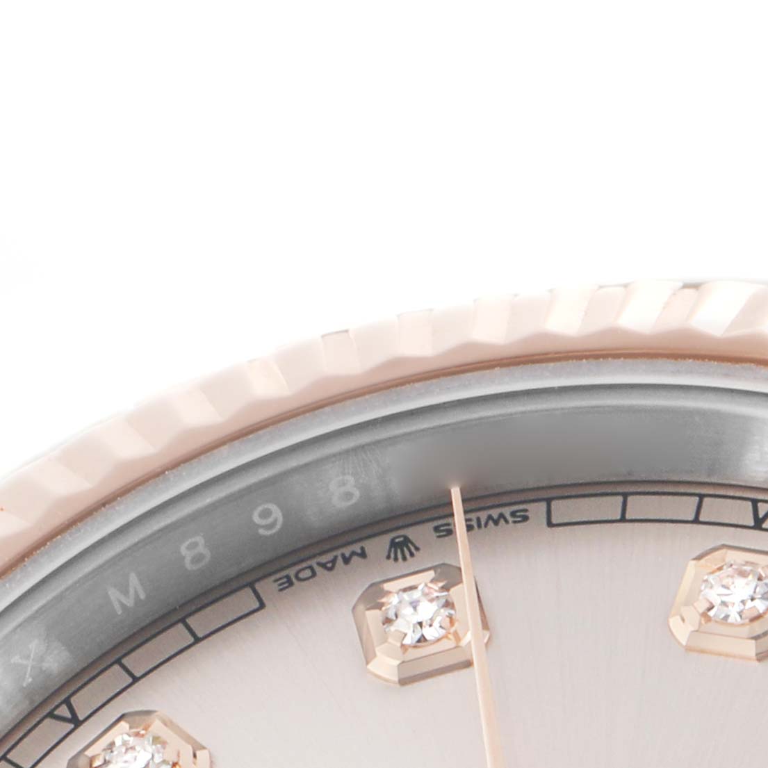 The image shows a close-up view of the Rolex Datejust 41 126331 Men's Steel and Gold (two tone) Pink Dial's bezel and part of its diamond-set dial.