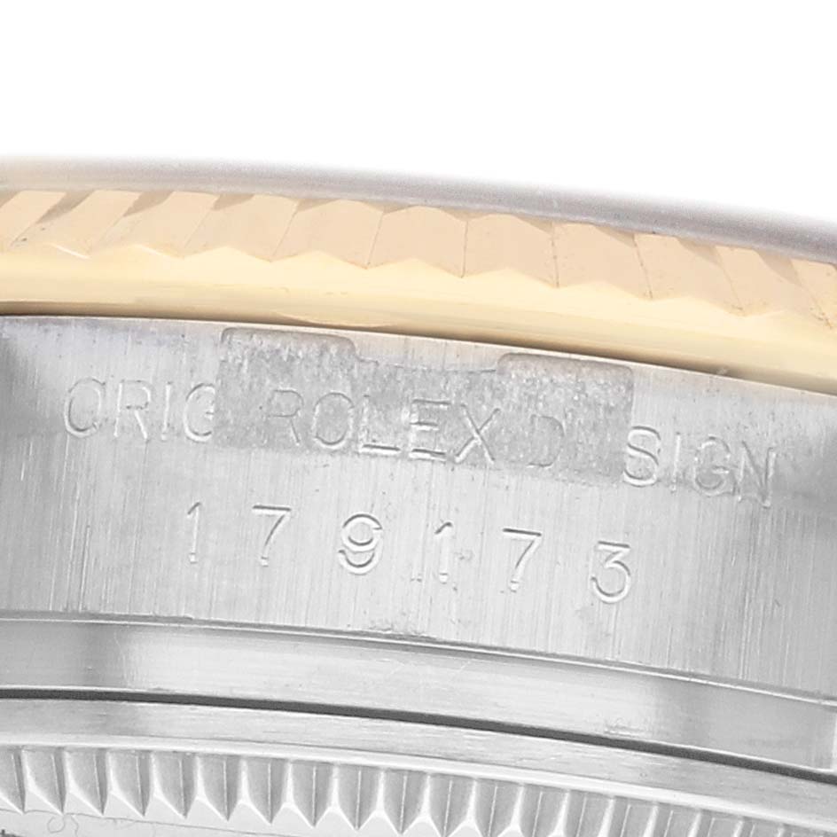 The image shows a close-up of the Rolex Datejust 179173 Women's Steel and Gold (two tone) Silver Dial's case side, highlighting the model number and engraving details.