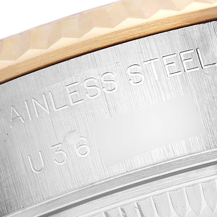 The image shows a close-up of the side and bezel edge of a Rolex Datejust 69173 Women's Steel and Gold (two tone) Black Dial 69173 Women's Steel and Gold (two tone) Black Dial, highlighting the "STAINLESS STEEL" engraving.