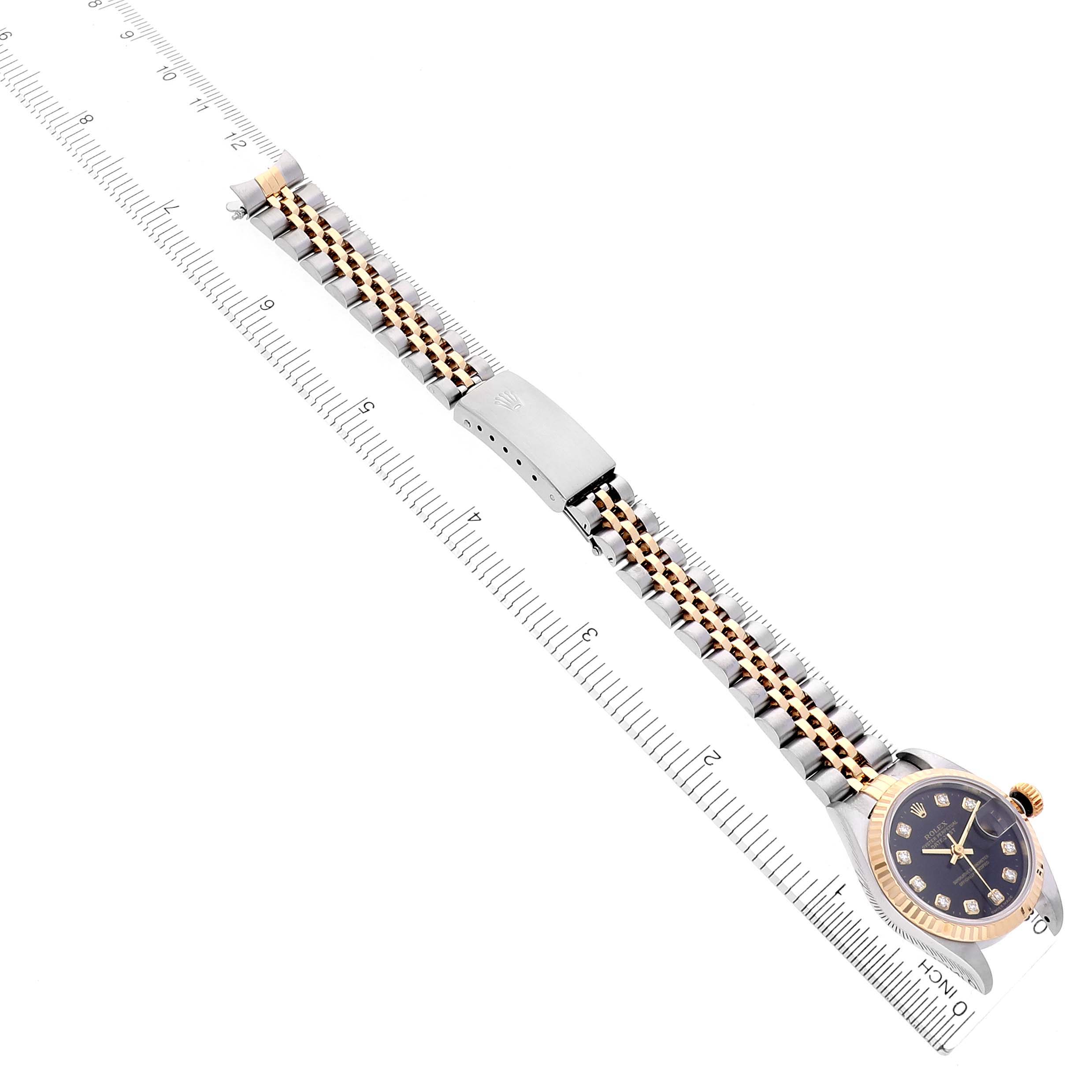 The Rolex Datejust 69173 Women's Steel and Gold (two tone) Black Dial 69173 Women's Steel and Gold (two tone) Black Dial watch is shown from a top view, displaying the full bracelet and face alongside a ruler.