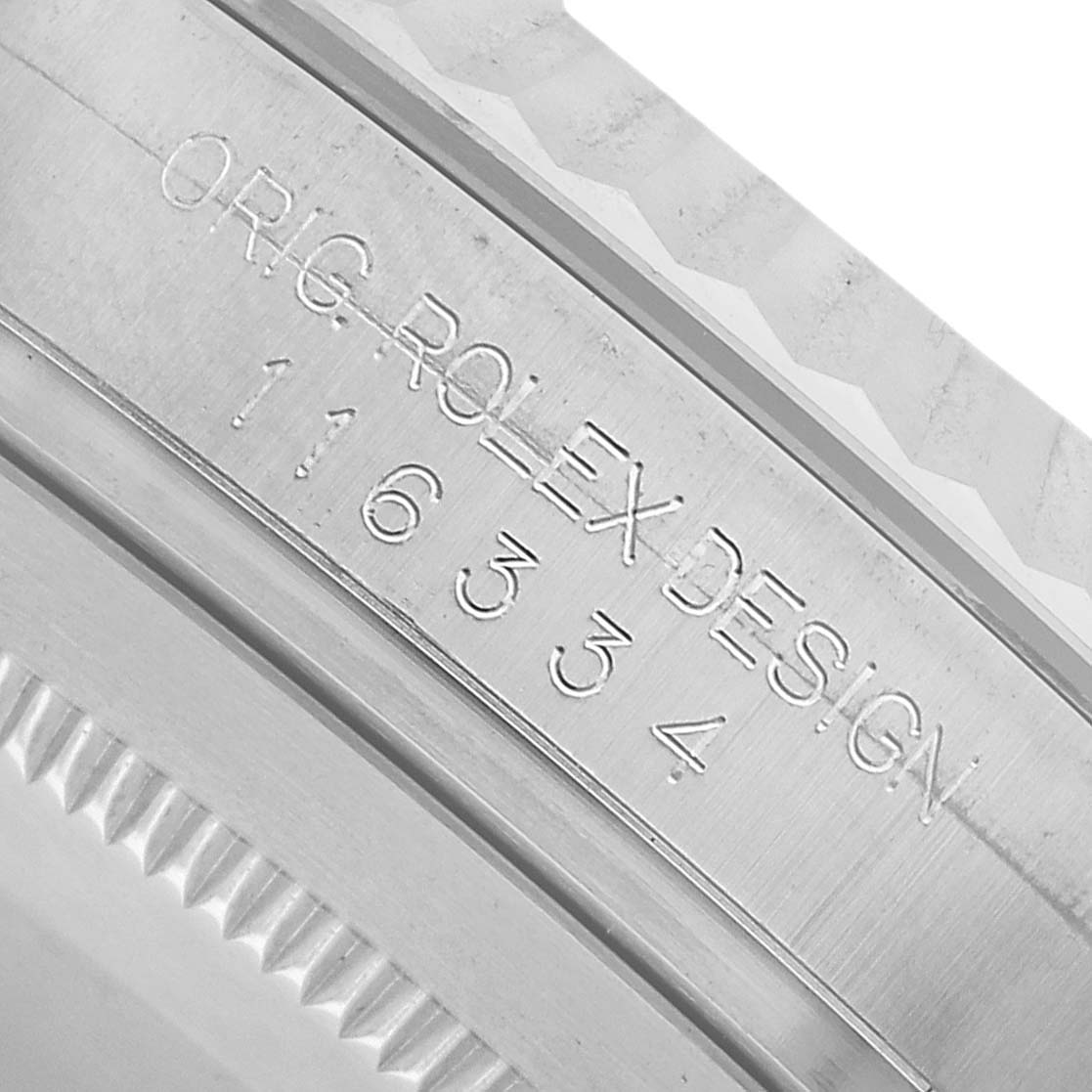 The image shows a close-up angle of the Rolex Datejust 41 116334 Men's Stainless Steel Blue Dial model's case with engraved branding and serial number.