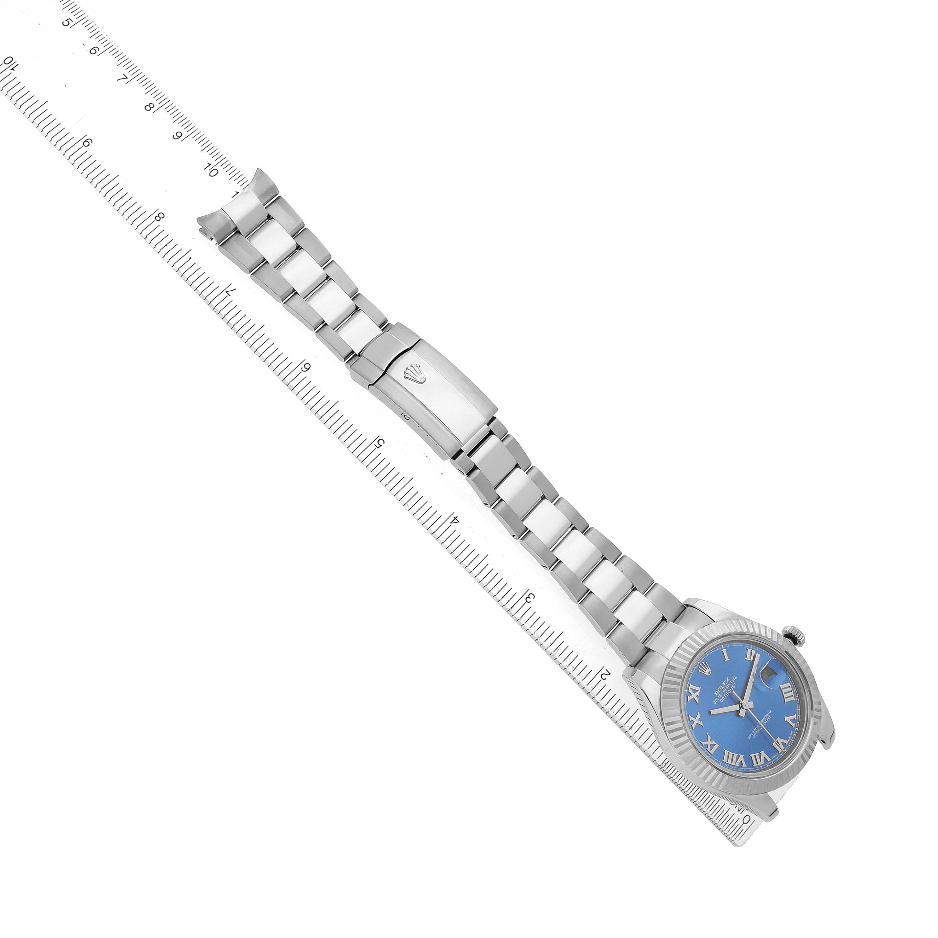 The Rolex Datejust 41 116334 Men's Stainless Steel Blue Dial is shown from an angled side view, displaying the full bracelet and face alongside a ruler.