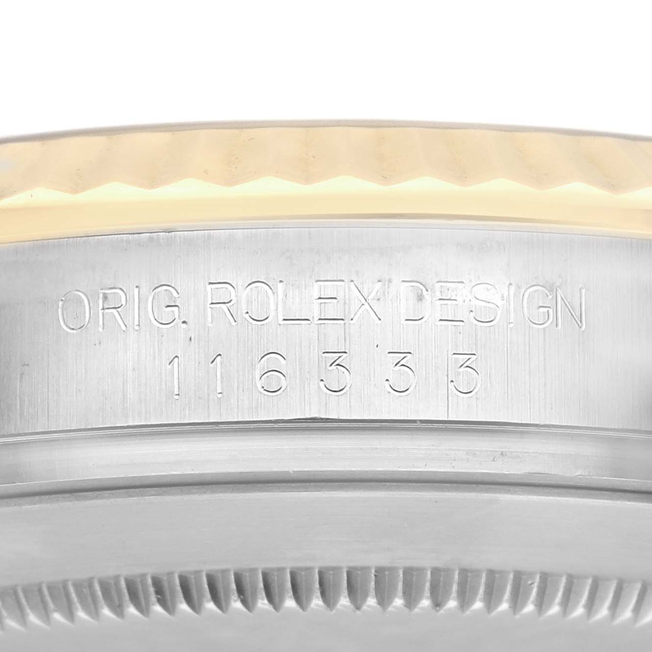 The image shows a close-up of the side of a Rolex Datejust 41 116333 Men's Steel and Gold (two tone) Grey Dial 116333 Men's Steel and Gold (two tone) Grey Dial, featuring engraved text and a fluted bezel.