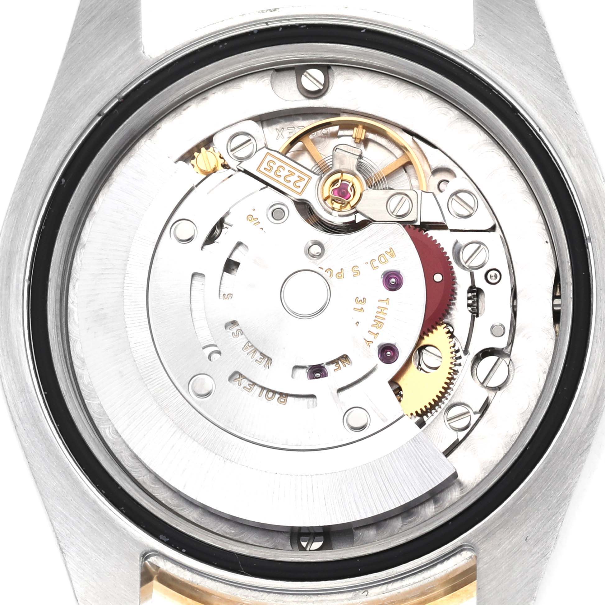 The image shows a close-up of the movement inside a Mid-Size Rolex watch with visible gears, screws, and rotors.