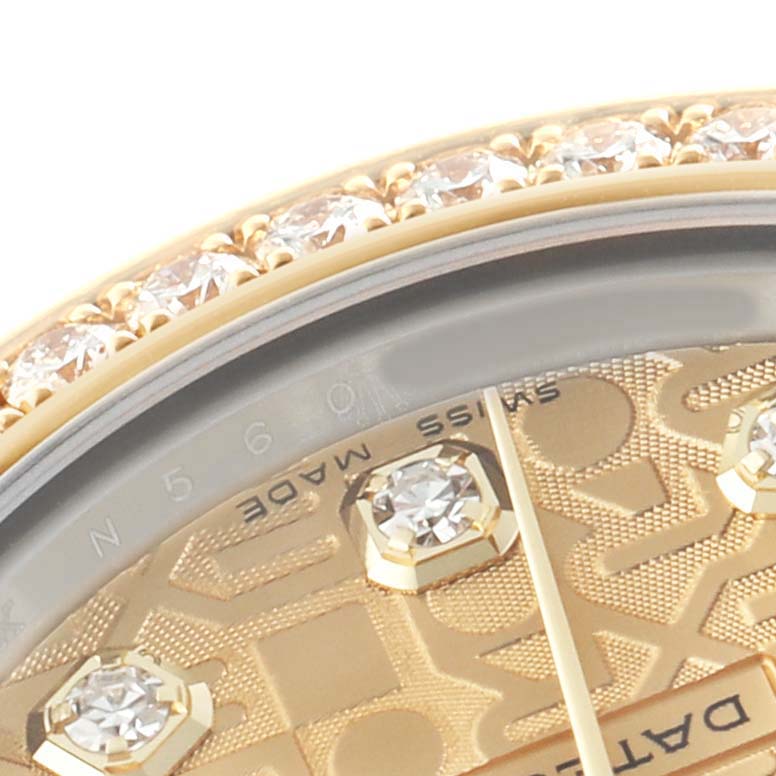 The Rolex Mid-Size M178383-0008 Women's Steel and Gold (two tone) Champagne Dial watch image shows a close-up of the bezel with diamonds and part of the dial displaying the "Swiss Made" text.