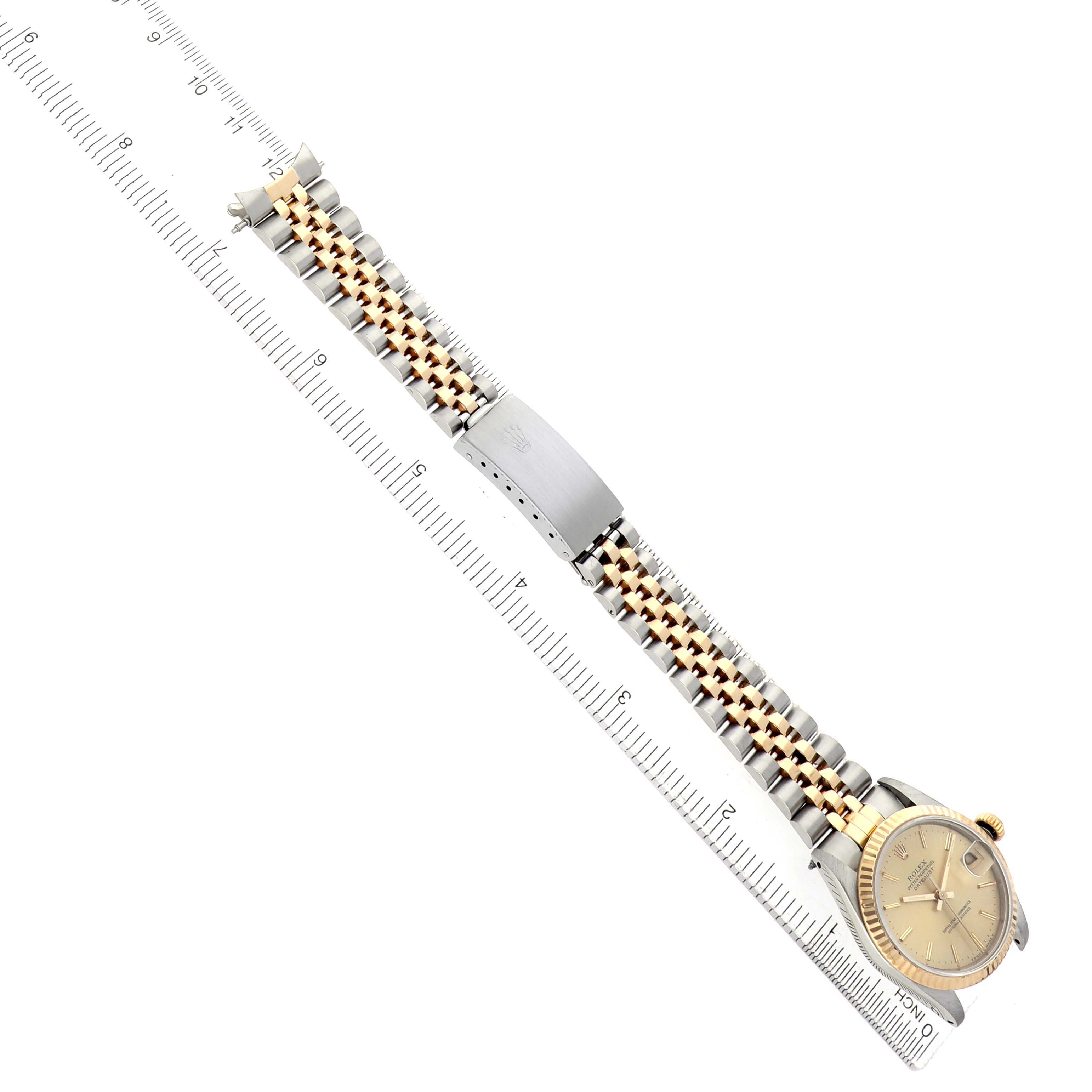 The Rolex Datejust 68273 Women's Steel and Gold (two tone) Champagne Dial watch is shown from a top view, displaying the face, bracelet, and clasp components.