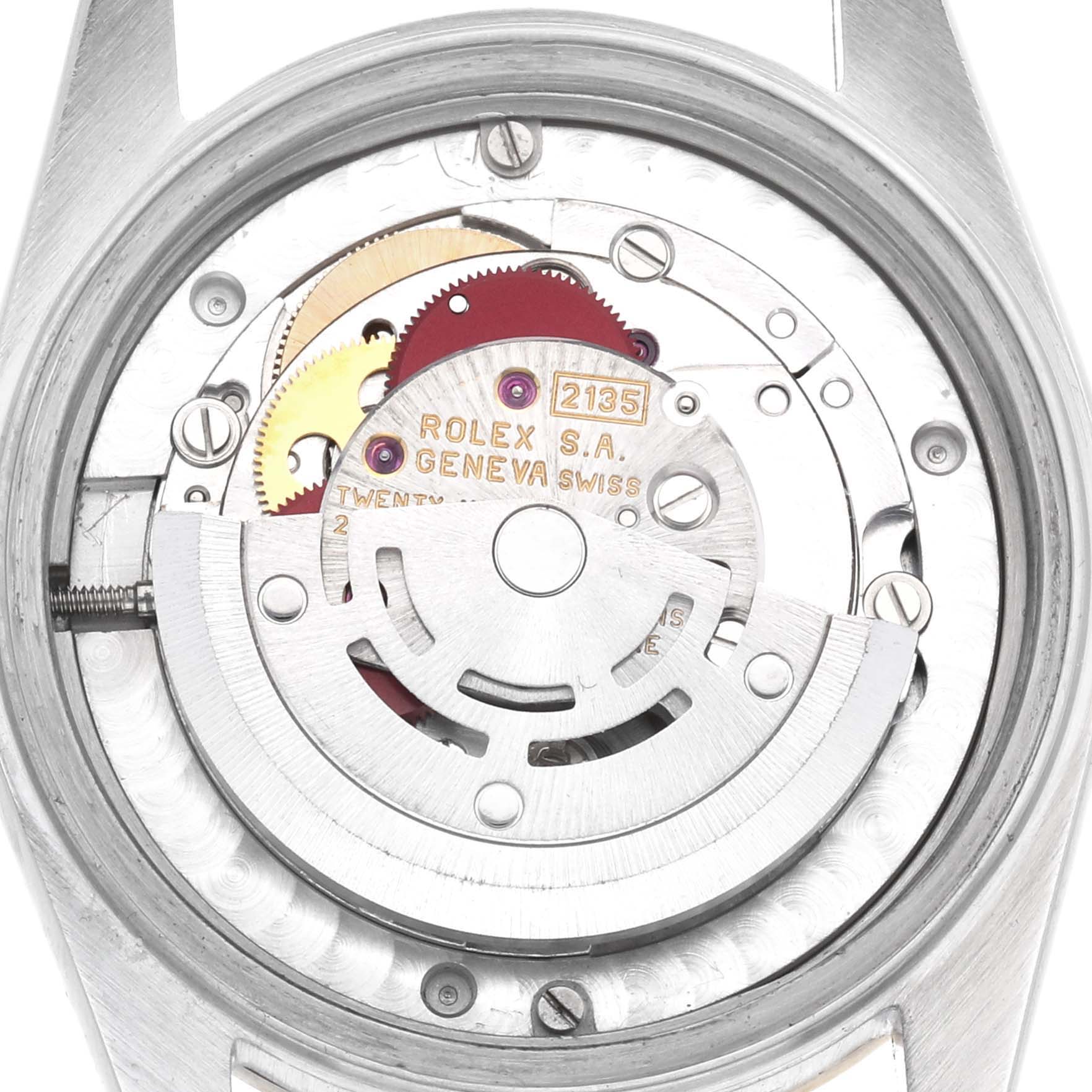 The image shows the movement mechanism of a Rolex Datejust 68273 Women's Steel and Gold (two tone) Champagne Dial, highlighting its gears and rotor from a top-down view.