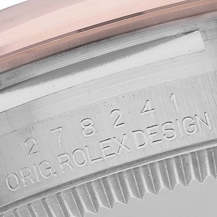 This image shows a close-up of the inner bezel with serial number engraving on a Mid-Size Rolex watch.
