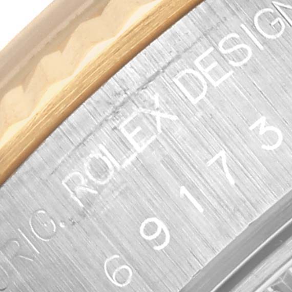 The image shows a close-up of the side of a Rolex Datejust 69173 Women's Steel and Gold (two tone) Beige Dial 69173 Women's Steel and Gold (two tone) Beige Dial, highlighting the engraved branding and model number.