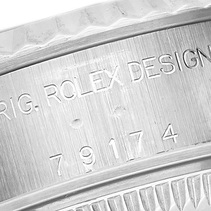The image shows a close-up of the side engraving on a Rolex Datejust 79174 Women's Stainless Steel Pink Dial 79174 Women's Stainless Steel Pink Dial watch case.