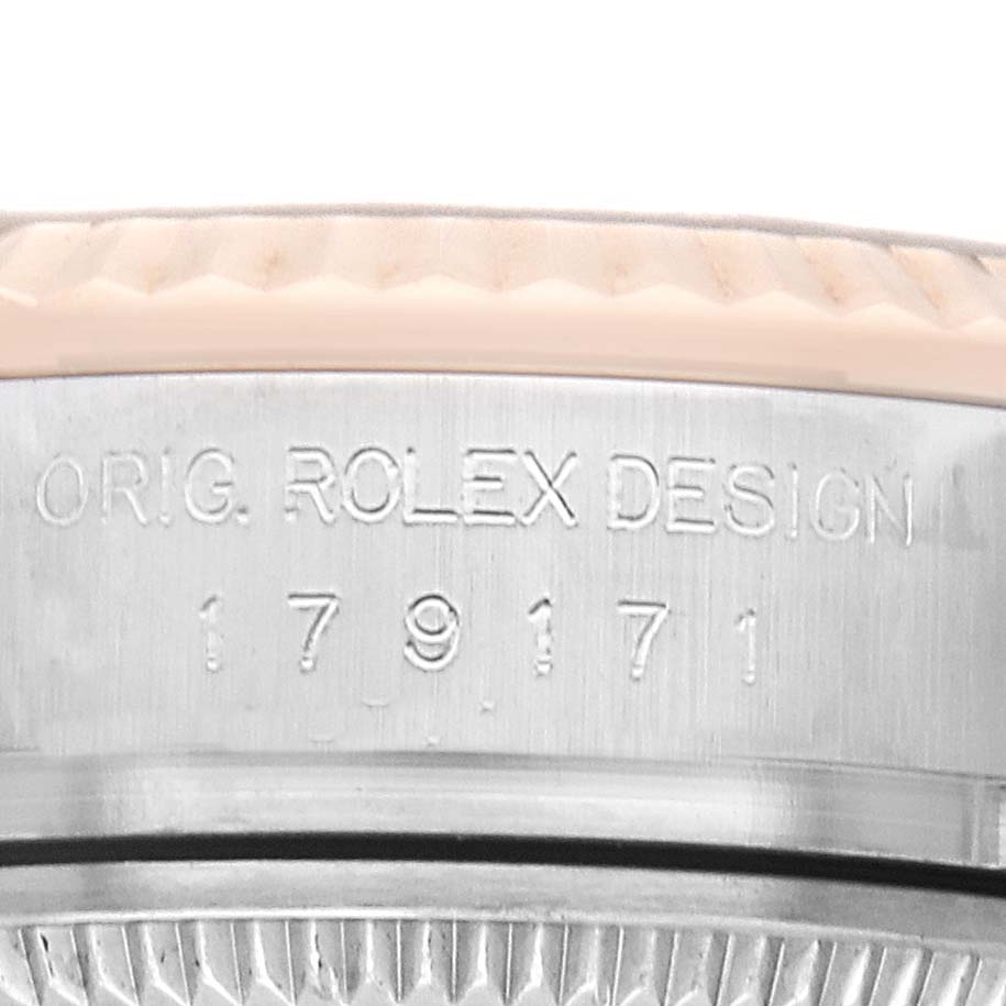 The image shows a close-up of the Rolex Datejust 179171 Women's Steel and Gold (two tone) Black Dial case side, displaying engraved writing and the bezel edge.
