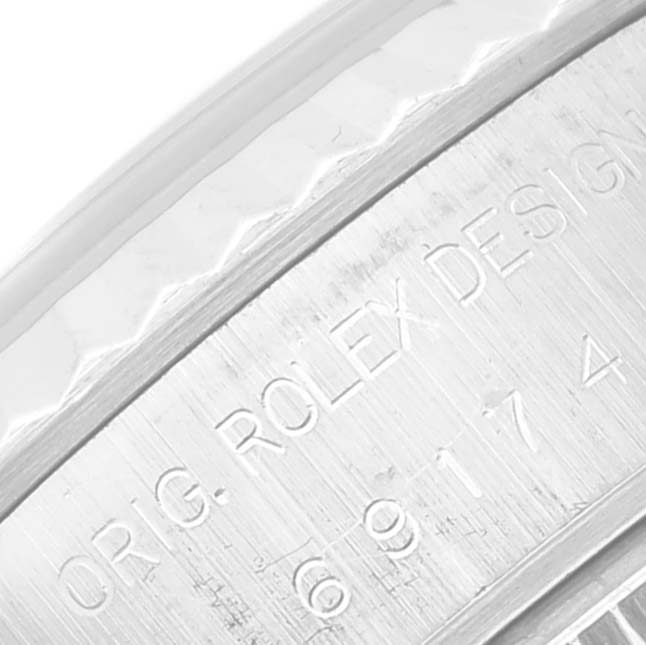 The image shows a close-up of the side engraving on the case of a Rolex Datejust 69174 Women's Stainless Steel Black Dial 69174 Women's Stainless Steel Black Dial watch.