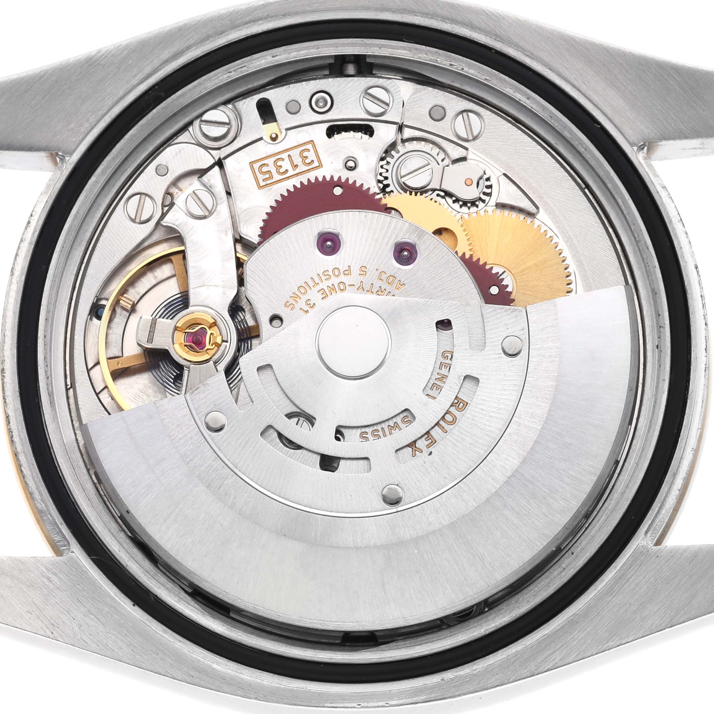 The image shows the movement of a Rolex Datejust 116243 Men's Steel and Gold (two tone) Black Dial, featuring gears and the rotor from a back angle.