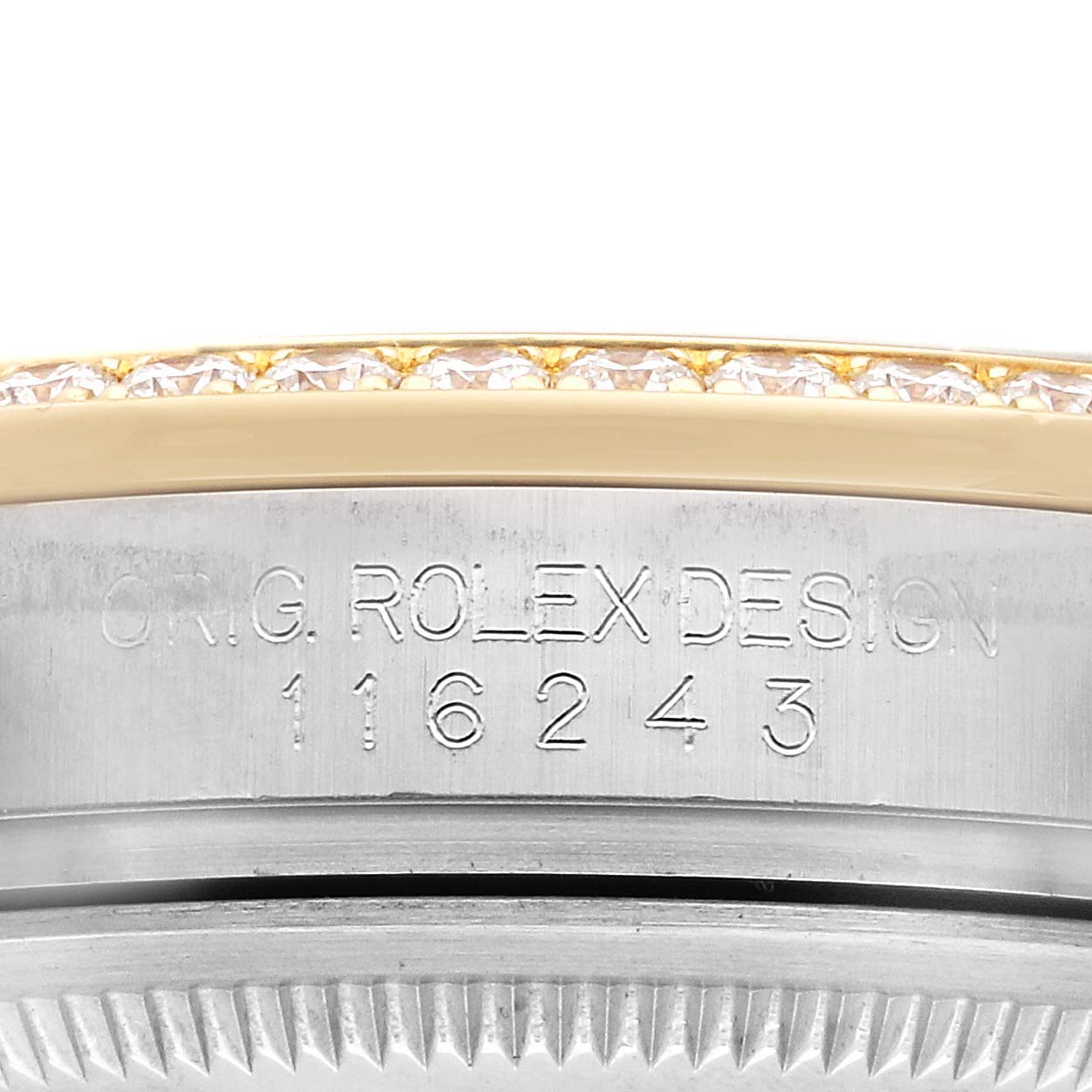 The image shows a close-up of a Rolex Datejust 116243 Men's Steel and Gold (two tone) Black Dial's engraved bezel and part of the gold and diamond-studded edge.