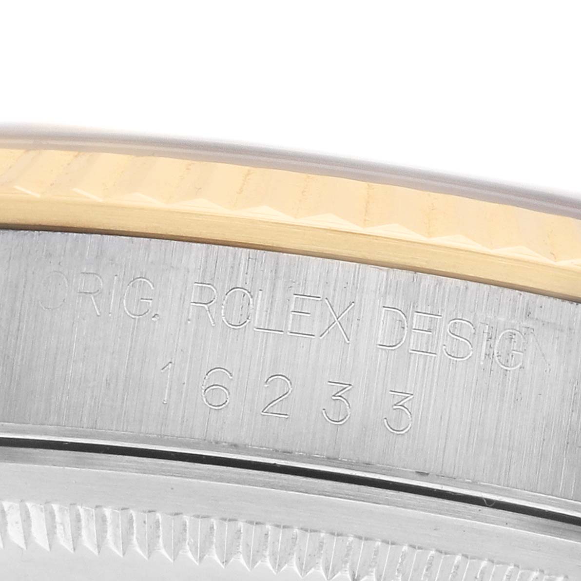 The image shows a close-up of the case side of a Rolex Datejust 16233 Men's Steel and Gold (two tone) Grey Dial, focusing on the model number and design engravings.