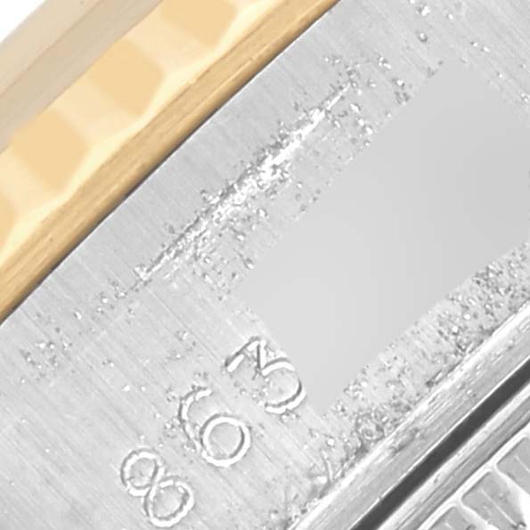 The image shows a close-up of the side view of a Rolex Date 69173 Women's Steel and Gold (two tone) Champagne Dial 69173 Women's Steel and Gold (two tone) Champagne Dial model, highlighting the metal casing and part of the bezel.