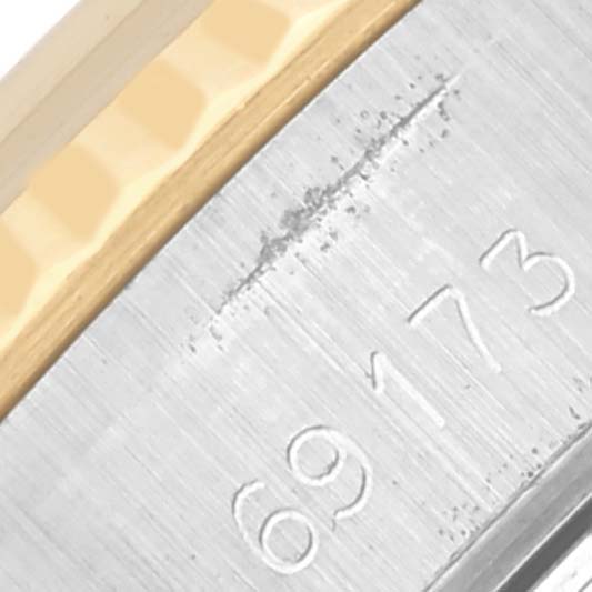 The image shows a close-up of the bezel and case side of a Rolex Date 69173 Women's Steel and Gold (two tone) Champagne Dial 69173 Women's Steel and Gold (two tone) Champagne Dial model, focusing on details and serial number.