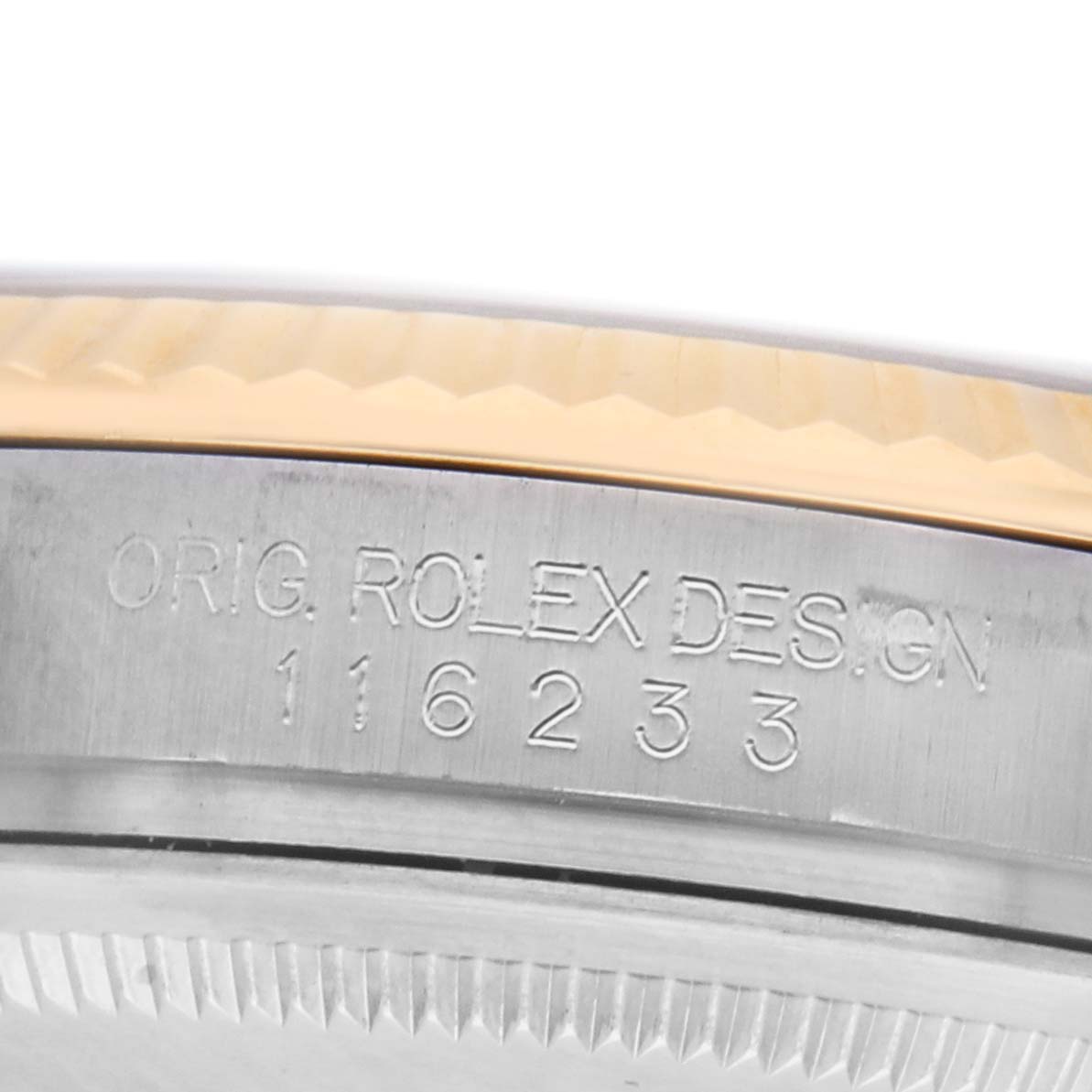 The image shows the side view of a Rolex Datejust 116233 Men's Steel and Gold (two tone) Black Dial model, highlighting the engraved model number and a portion of the bezel.