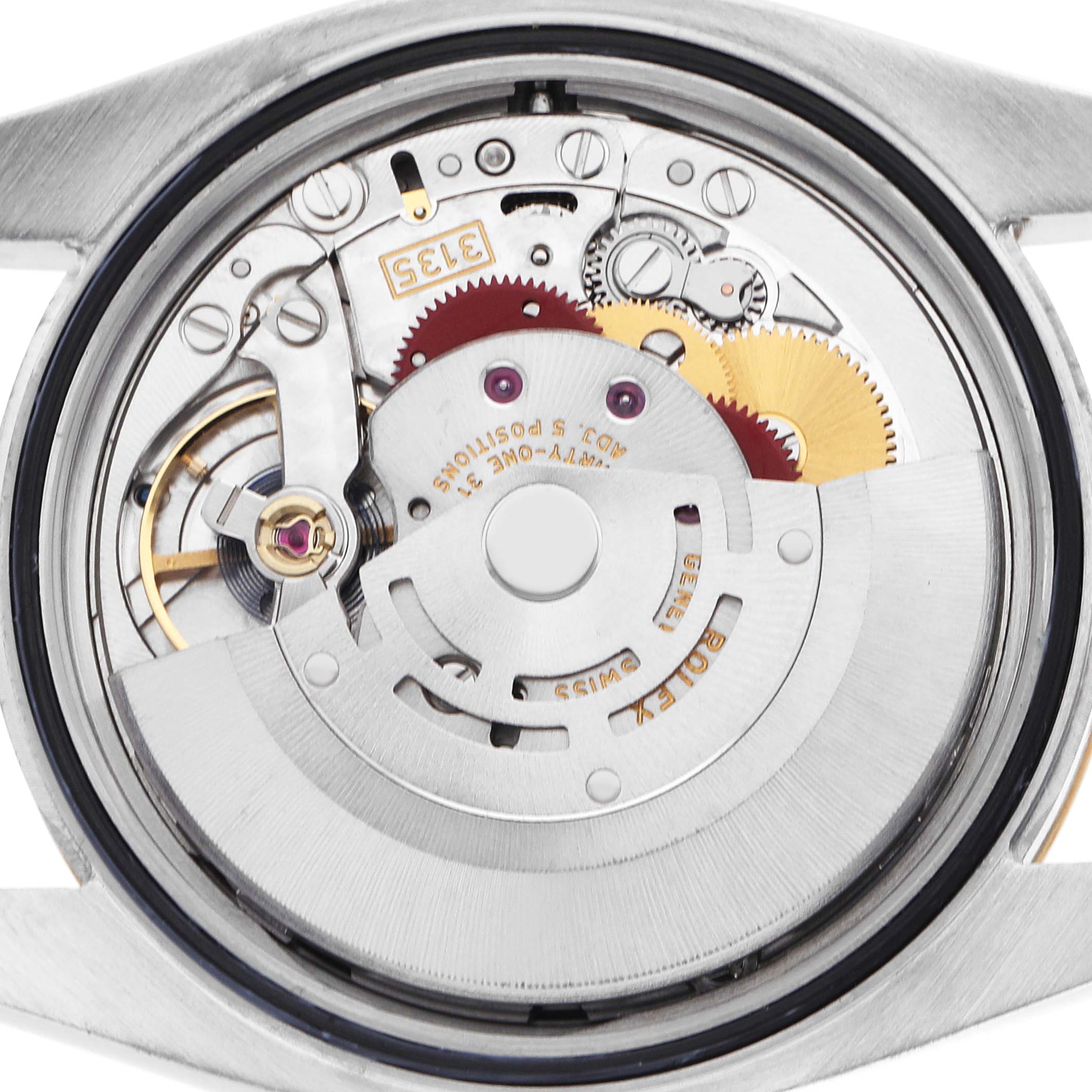 The image shows the movement of a Rolex Datejust 116233 Men's Steel and Gold (two tone) Black Dial watch from a back angle, highlighting gears and mechanical components.