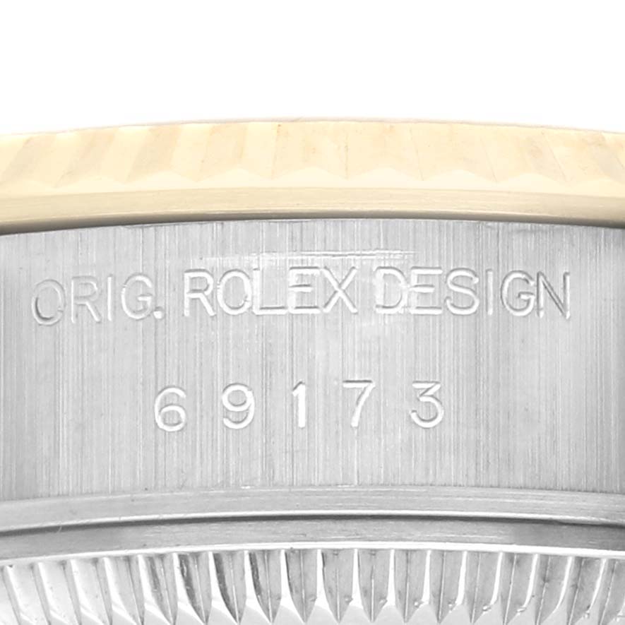 The image shows the side of the Rolex Datejust 69173 Women's Steel and Gold (two tone) Champagne Dial 69173 Women's Steel and Gold (two tone) Champagne Dial case with the model number and "Orig. Rolex Design" engraving.