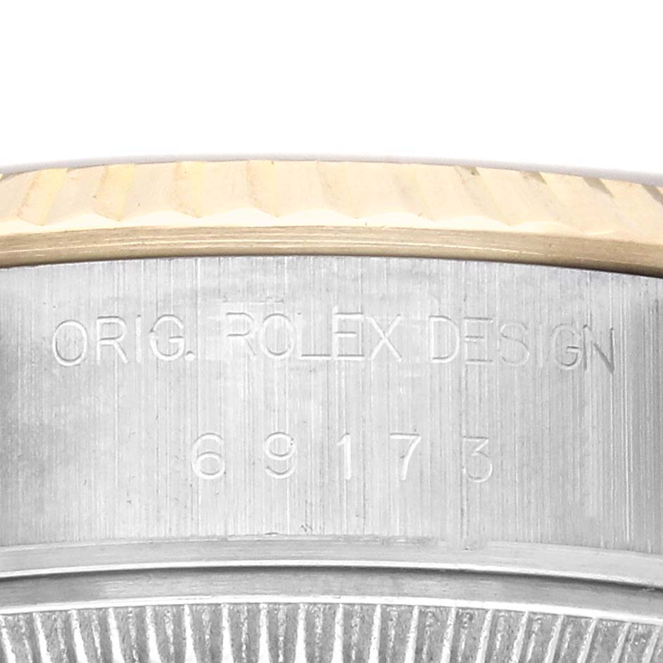 The image shows a close-up of the side of a Rolex Datejust 69173 Women's Steel and Gold (two tone) Champagne Dial 69173 Women's Steel and Gold (two tone) Champagne Dial, focusing on the engraved reference numbers and part of the fluted bezel.