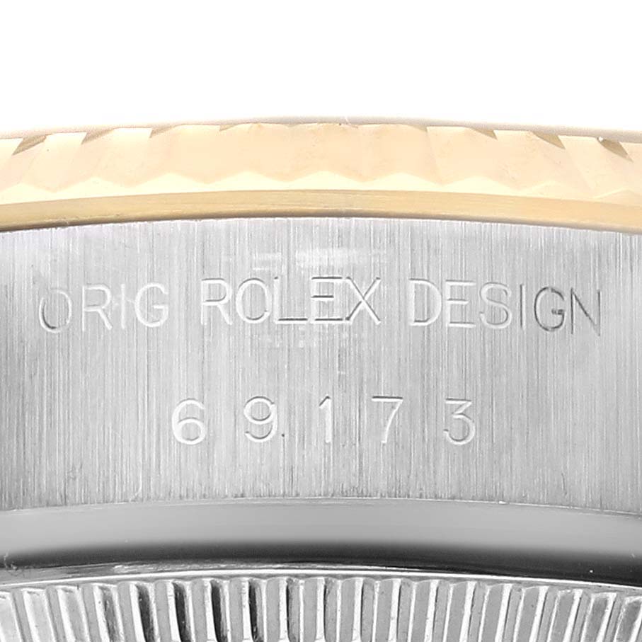 The image is a close-up of the Rolex Datejust 69173 Women's Steel and Gold (two tone) Champagne Dial 69173 Women's Steel and Gold (two tone) Champagne Dial watch's side, showing the engraved model number 69173.