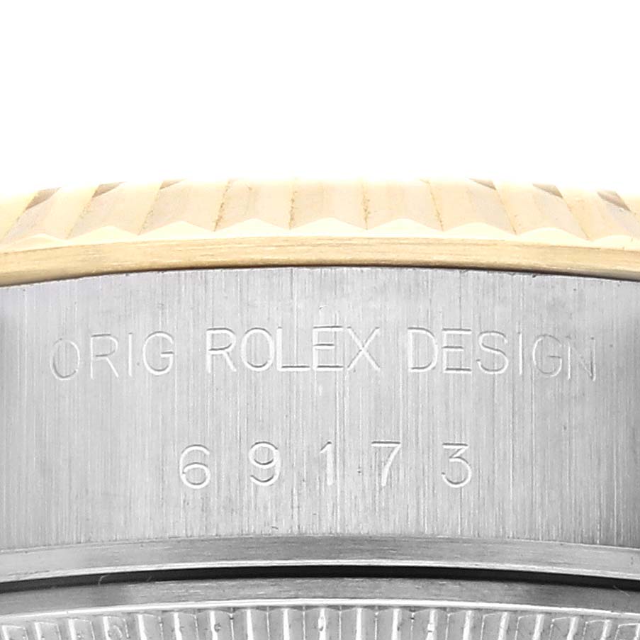The image shows a partial side view of the Rolex Datejust 69173 Women's Steel and Gold (two tone) Champagne Dial 69173 Women's Steel and Gold (two tone) Champagne Dial, featuring the bezel and engraved case side.