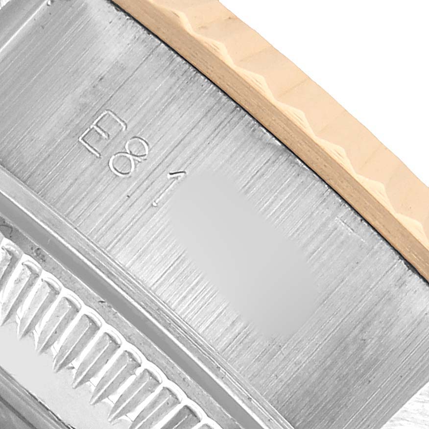 The image shows a close-up of the Rolex Datejust 69173 Women's Steel and Gold (two tone) White Dial's case side, focusing on the bezel and part of the case engravings.