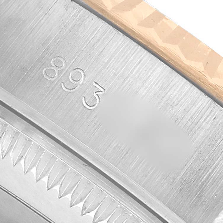The image shows a close-up of the serial number engraving on the side of a Rolex Datejust 69173 Women's Steel and Gold (two tone) White Dial watch case.