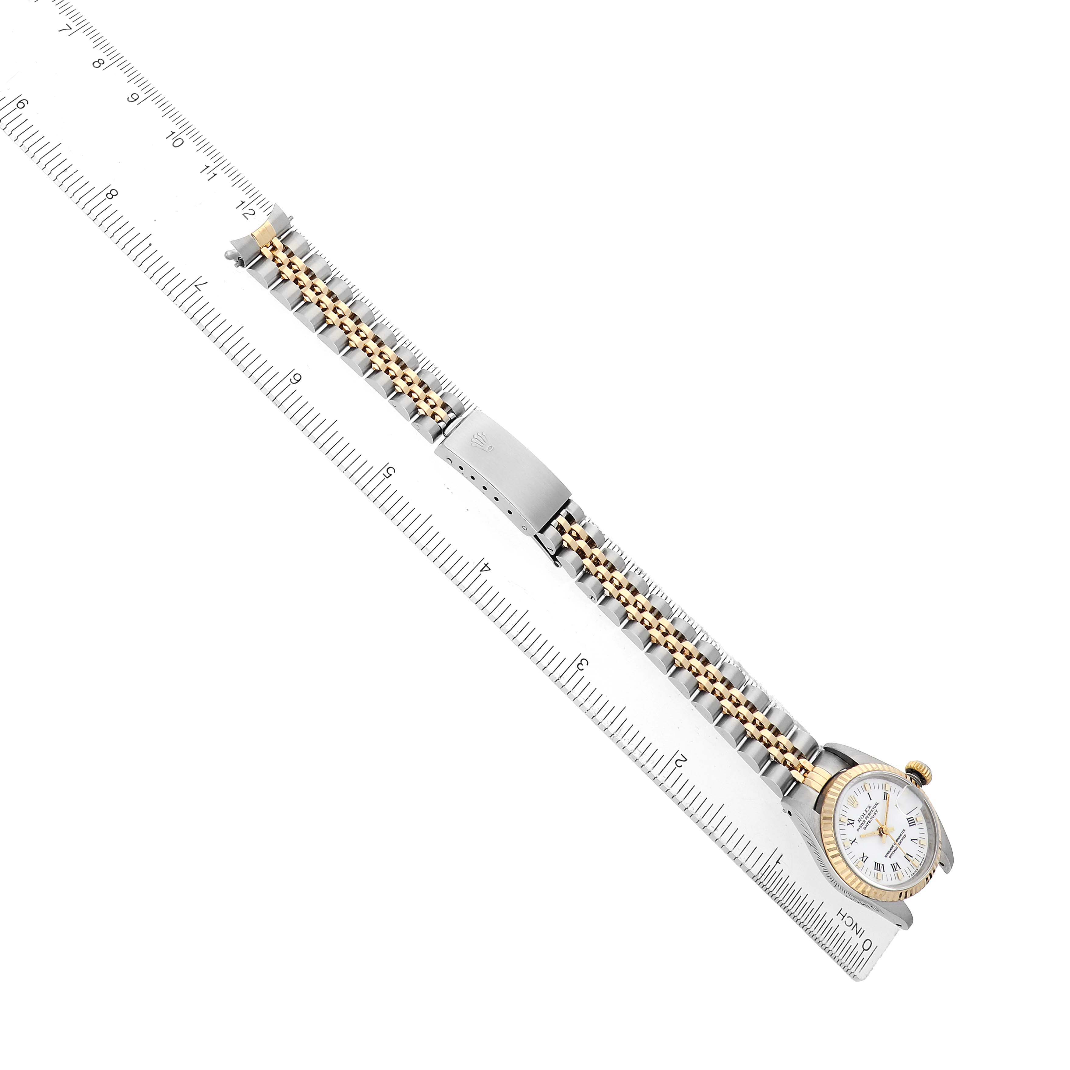 The Rolex Datejust 69173 Women's Steel and Gold (two tone) White Dial watch is shown from a top angle, featuring the full bracelet, clasp, and face.
