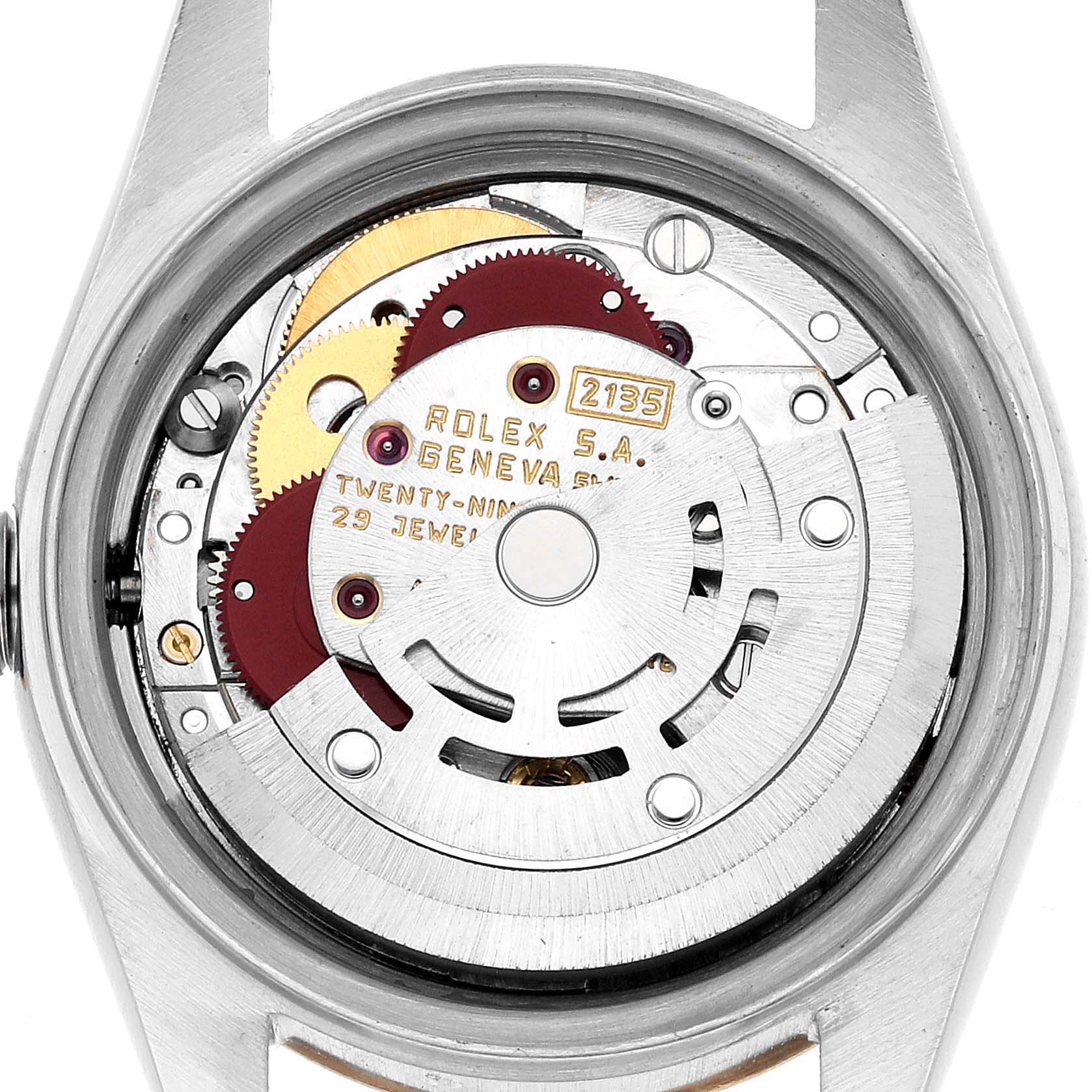 The image shows the movement of a Rolex Datejust 69173 Women's Steel and Gold (two tone) White Dial watch from the back, highlighting gears and the rotor mechanism.
