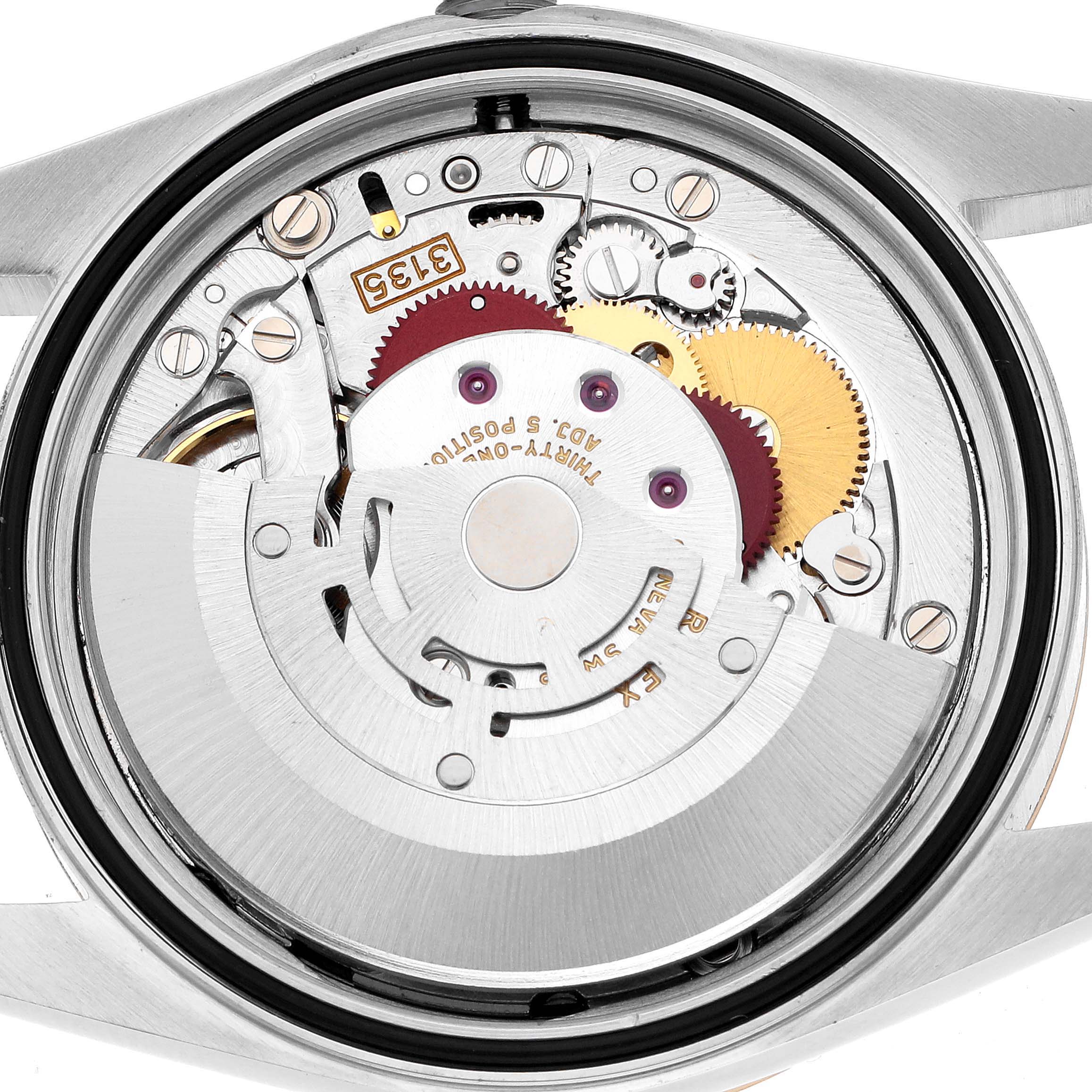 The image shows a close-up of the movement of a Rolex Datejust 16233 Men's Steel and Gold (two tone) White Dial watch from the back, highlighting gears and components.