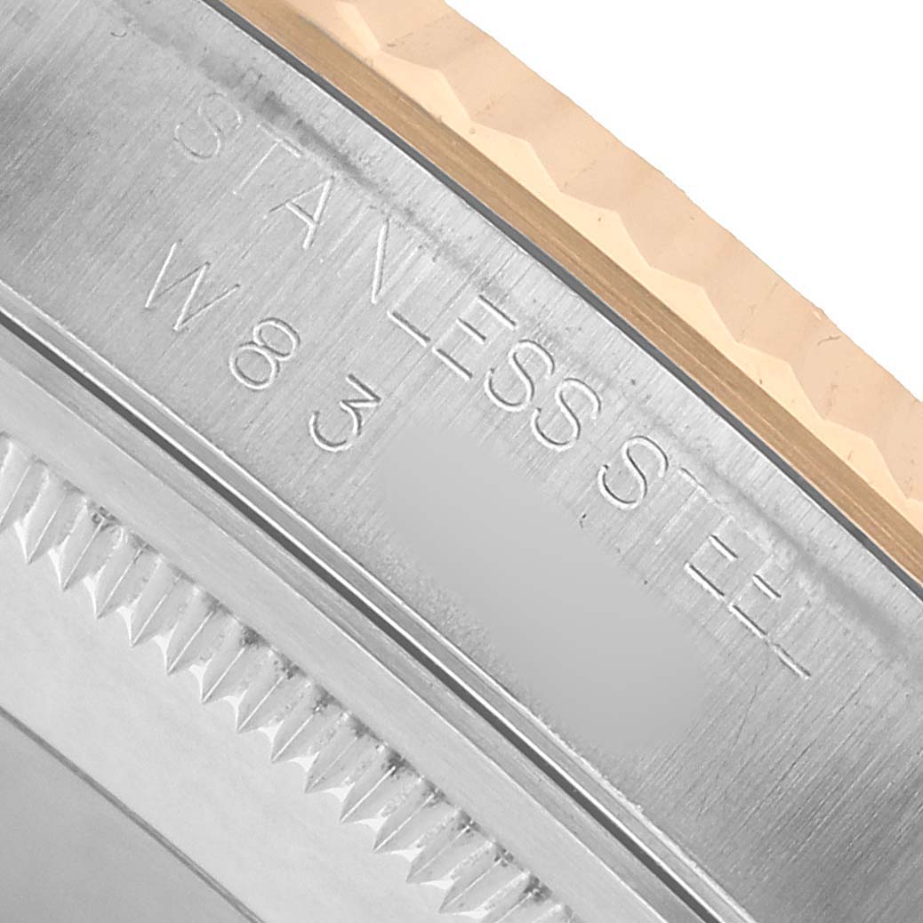 The image shows a close-up angle of the case side and edge of the bezel of a Rolex Datejust 16233 Men's Steel and Gold (two tone) White Dial with "Stainless Steel" engraving.