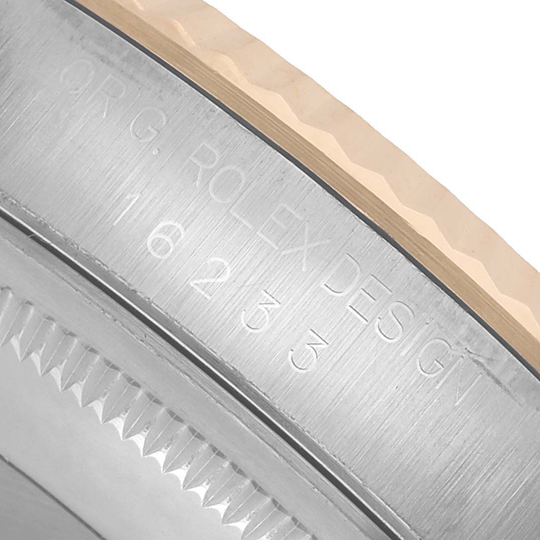 The image shows a close-up of the side of a Rolex Datejust 16233 Men's Steel and Gold (two tone) White Dial watch, focusing on the engraved details and part of the bezel.
