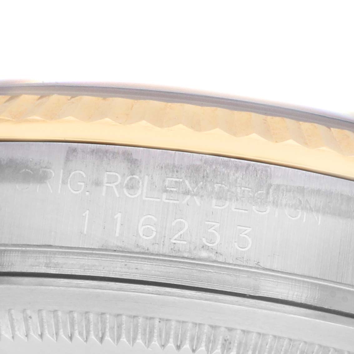 The image shows the side view of a Rolex Datejust 116233 Men's Steel and Gold (two tone) White Dial model, focusing on the engraved serial number and fluted bezel.