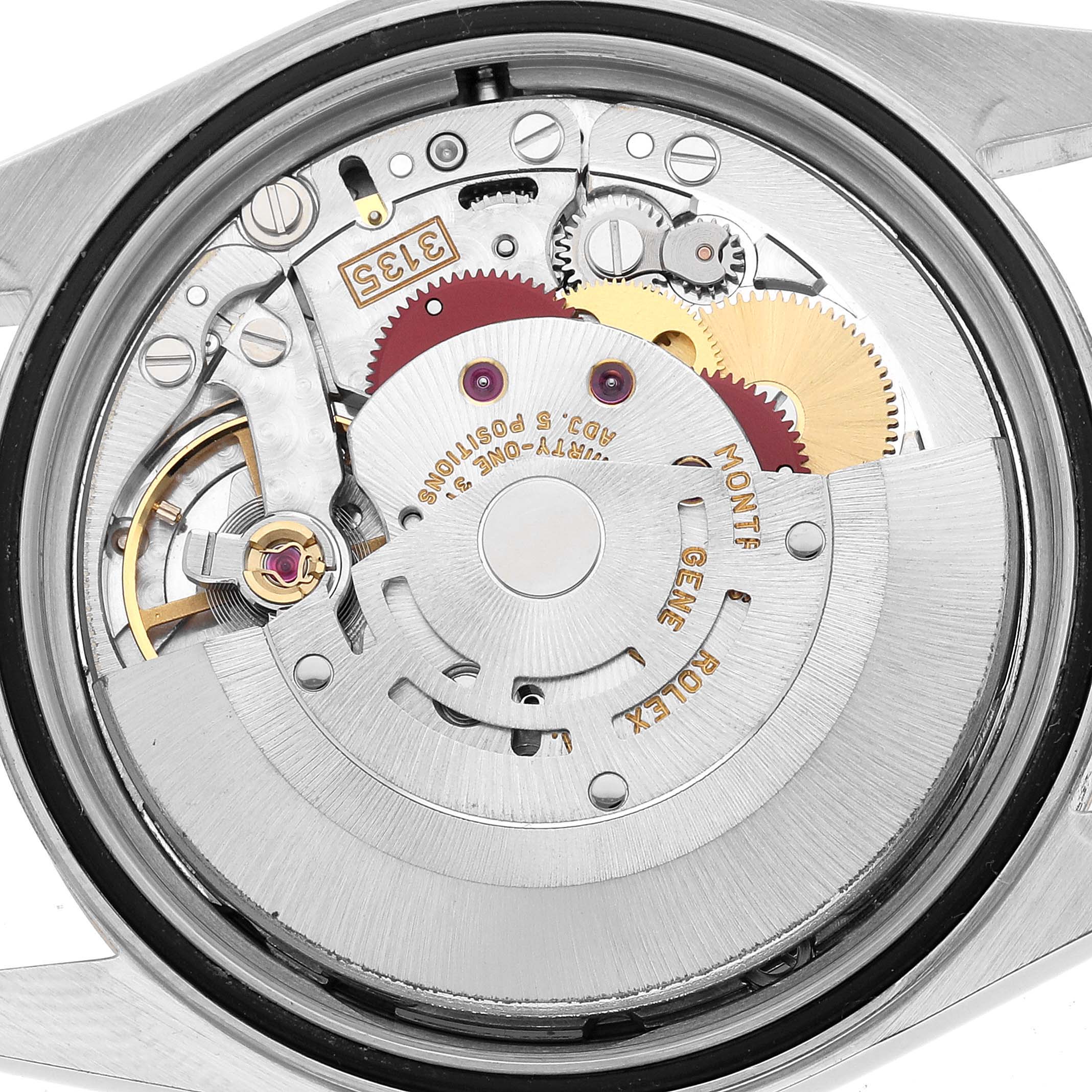 The image shows the movement mechanism of a Rolex Datejust 16233 Men's Steel and Gold (two tone) White Dial watch from the back, highlighting gears and intricate components.