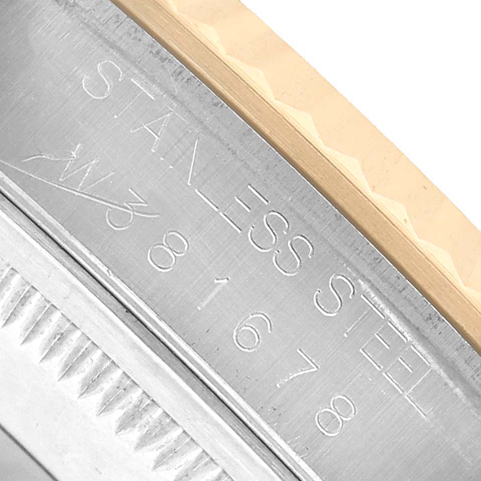 The image shows a close-up angle of the bezel and part of the case with engravings on a Rolex Datejust 16233 Men's Steel and Gold (two tone) White Dial watch.