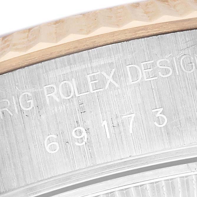 The image shows a close-up of the side of a Rolex Datejust 69173 Women's Steel and Gold (two tone) White Dial 69173 Women's Steel and Gold (two tone) White Dial watch, highlighting the engraved model number and design details.