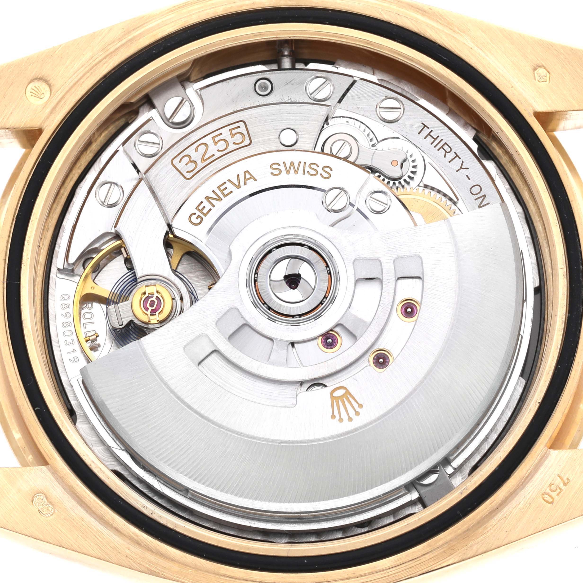 The image shows the movement of a Rolex President 228348 Men's Yellow Gold Black Dial watch, focusing on the rotor and intricate inner mechanisms.